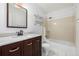 Bathroom featuring a vanity with marble countertop and a shower-tub combo with tiled walls at 550 S Xenon Ct, Lakewood, CO 80228