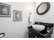 Elegant powder room featuring a vessel sink, stylish mirror, and tasteful decor at 550 S Xenon Ct, Lakewood, CO 80228