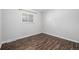 Empty bedroom featuring a window offering natural light and wood-look flooring at 550 S Xenon Ct, Lakewood, CO 80228