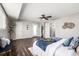 Well-lit bedroom featuring wood-look floors and access to the bathroom and closet at 550 S Xenon Ct, Lakewood, CO 80228