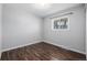 Empty bedroom featuring a window offering natural light and wood-look flooring at 550 S Xenon Ct, Lakewood, CO 80228