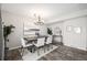 Dining room features hardwood floors, neutral walls, elegant lighting, and stylish decor at 550 S Xenon Ct, Lakewood, CO 80228