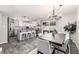 Bright, modern eat-in kitchen with white cabinets, stainless appliances, granite countertops and gray wood flooring at 550 S Xenon Ct, Lakewood, CO 80228