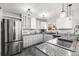 Bright kitchen with stainless steel refrigerator, granite countertops, and white cabinets at 550 S Xenon Ct, Lakewood, CO 80228