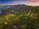 Beautiful aerial view showing the neighborhood nestled in a vibrant forest surrounded by mountains at 11163 Conifer Mountain Rd, Conifer, CO 80433