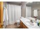 Neutral bathroom featuring a white shower curtain, oak cabinets and neutral countertops at 11163 Conifer Mountain Rd, Conifer, CO 80433