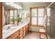 Inviting bathroom boasting double sinks, wood trim, and a glass-enclosed shower at 11163 Conifer Mountain Rd, Conifer, CO 80433