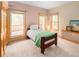 Inviting bedroom with a balcony access featuring ample natural light and cozy carpet at 11163 Conifer Mountain Rd, Conifer, CO 80433