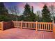 Beautiful deck with wood railings and floor overlooking the surrounding landscape at 11163 Conifer Mountain Rd, Conifer, CO 80433