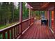 Cozy wood deck with patio furniture and views of the surrounding woods at 11163 Conifer Mountain Rd, Conifer, CO 80433