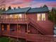 Charming multi-level home featuring a wooden deck, wood siding, and beautiful outdoor stairway at 11163 Conifer Mountain Rd, Conifer, CO 80433