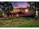Multi-story home featuring a sprawling wooden deck and stunning natural surroundings at 11163 Conifer Mountain Rd, Conifer, CO 80433