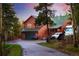 Inviting home with a green roof, large garage, and ample parking, perfect for outdoor living and adventures at 11163 Conifer Mountain Rd, Conifer, CO 80433