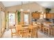Eat-in kitchen with hardwood table, stainless appliances, and access to outdoor grilling area at 11163 Conifer Mountain Rd, Conifer, CO 80433