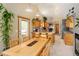 Bright kitchen with stainless appliances, hardwood table, and easy access to outdoor areas at 11163 Conifer Mountain Rd, Conifer, CO 80433