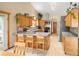 Spacious kitchen with stainless steel appliances, island with seating, and ample counter space at 11163 Conifer Mountain Rd, Conifer, CO 80433