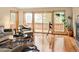 Bright living room featuring hardwood floors, a telescope, and views of the surrounding nature at 11163 Conifer Mountain Rd, Conifer, CO 80433