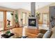 Stylish living area with a modern fireplace, hardwood floors, and access to a private outdoor deck at 11163 Conifer Mountain Rd, Conifer, CO 80433