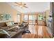Bright and airy living room with hardwood floors, comfortable sofas, and access to an outdoor deck at 11163 Conifer Mountain Rd, Conifer, CO 80433