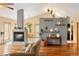 Open-concept living space with modern fireplace, hardwood floors, and seamless flow to the dining area at 11163 Conifer Mountain Rd, Conifer, CO 80433