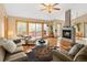 Inviting living room with hardwood floors, fireplace, and natural light from large windows at 11163 Conifer Mountain Rd, Conifer, CO 80433