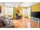 Bright living room with hardwood floors, neutral walls, and ample natural light from large windows at 11163 Conifer Mountain Rd, Conifer, CO 80433