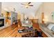 Open living room boasts hardwood floors, vaulted ceiling, and access to other areas of the home at 11163 Conifer Mountain Rd, Conifer, CO 80433