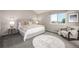 Bright bedroom featuring a large window, neutral carpet, and serene decor at 670 Somerset Dr, Golden, CO 80401