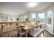 Dining area featuring a wooden table with seating, complemented by natural light from surrounding windows at 670 Somerset Dr, Golden, CO 80401