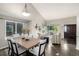 Open-concept dining room features a contemporary table set and bright natural light from nearby windows at 670 Somerset Dr, Golden, CO 80401