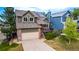 Charming two-story home with a front-facing garage, manicured lawn, and inviting deck with solar panels at 670 Somerset Dr, Golden, CO 80401