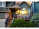 Charming front porch with wooden railings, brick accents, and lush greenery at 670 Somerset Dr, Golden, CO 80401