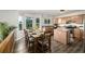 Open concept kitchen with wood cabinets, granite countertops, island, and a dining table with natural light at 670 Somerset Dr, Golden, CO 80401