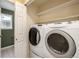 Bright laundry room with modern, white washer and dryer, plus an adjacent room with a window at 670 Somerset Dr, Golden, CO 80401