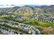 Aerial view of a neighborhood nestled in rolling hills with lush greenery and picturesque landscapes at 670 Somerset Dr, Golden, CO 80401