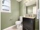 Stylish powder room with dark vanity, granite counters, and updated fixtures at 670 Somerset Dr, Golden, CO 80401