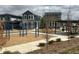 Community playground with swings, picnic tables, and walking paths between modern homes at 716 Belay St, Erie, CO 80516