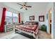 Inviting bedroom showcasing natural light and a unique ceiling fan and charming accents at 7987 Yampa River Ave, Littleton, CO 80125