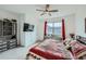Bright bedroom features an oversized window, wall-mounted tv, and customized built-in storage at 7987 Yampa River Ave, Littleton, CO 80125