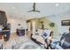 Open-concept living area with wood floors, stylish ceiling fan, and neutral color palette at 7987 Yampa River Ave, Littleton, CO 80125