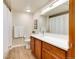 Clean bathroom with a white quartz countertop and wood cabinets at 7240 W Custer Ave # 307, Lakewood, CO 80226