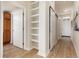 Bright entry hall with built-in shelving and wood-look floors at 7240 W Custer Ave # 307, Lakewood, CO 80226