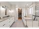 Spa-like bathroom with double vanity, soaking tub, and walk-in shower at 3260 S Corona St, Englewood, CO 80113