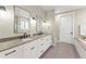 Bright bathroom features a double vanity and a walk-in shower at 3260 S Corona St, Englewood, CO 80113