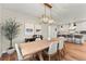 Modern dining room with light wood table and chandelier at 3260 S Corona St, Englewood, CO 80113