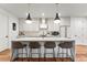 Modern kitchen with white cabinets, quartz countertops, and island with seating at 3260 S Corona St, Englewood, CO 80113