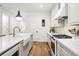 Modern kitchen with white cabinets, farmhouse sink, and gas range at 3260 S Corona St, Englewood, CO 80113