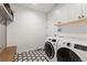 Clean laundry room with washer, dryer, and built-in storage at 3260 S Corona St, Englewood, CO 80113