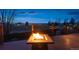 Fire pit on deck with a view of the city skyline at dusk at 10891 Parker Vista Rd, Parker, CO 80138