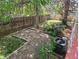 A partially fenced backyard features stone pavers and mature trees at 2750 S Rifle St, Aurora, CO 80013